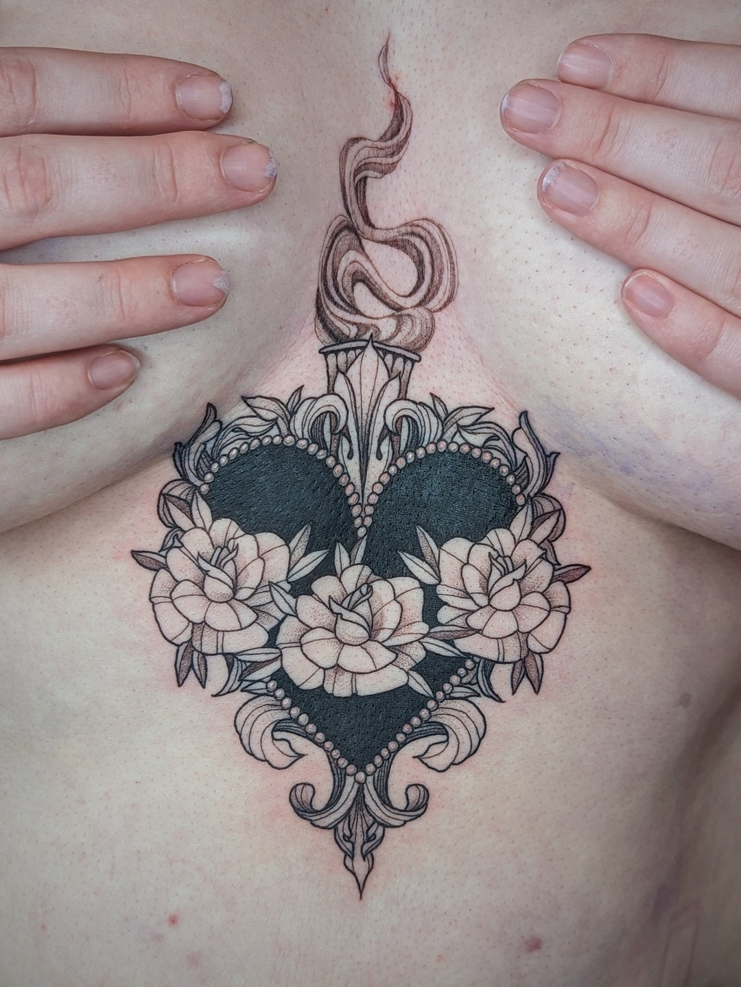 Fine line flower tattoo on the side boob.